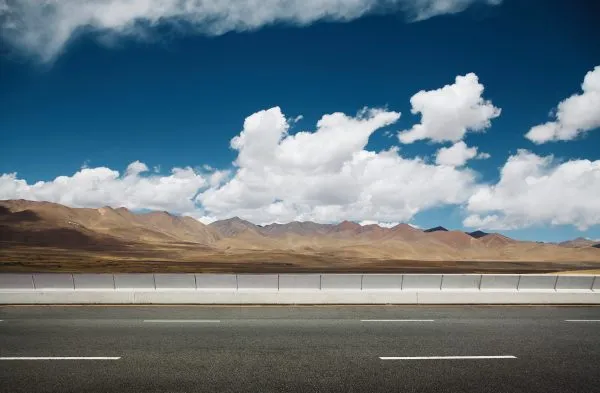 Empty asphalt road and mountain background .