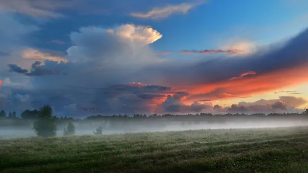Sunset over a misty field in countryside Latvia